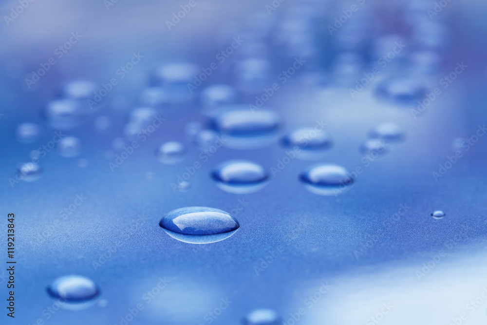 water drops on blue car body threated with protective coating water drops on blue car body threated with protective coating
