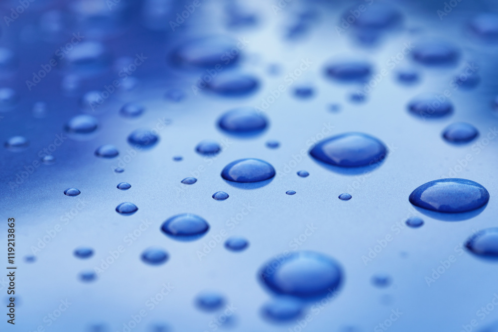 water drops on blue car body threated with protective coating water drops on blue car body threated with protective coating