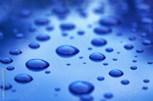 water drops on blue car body threated with protective coating photo