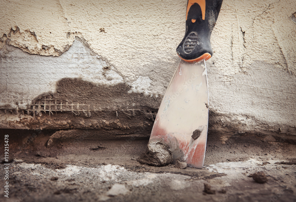 Repairing hole between wall and pavement, cement epoxy mixture Stock