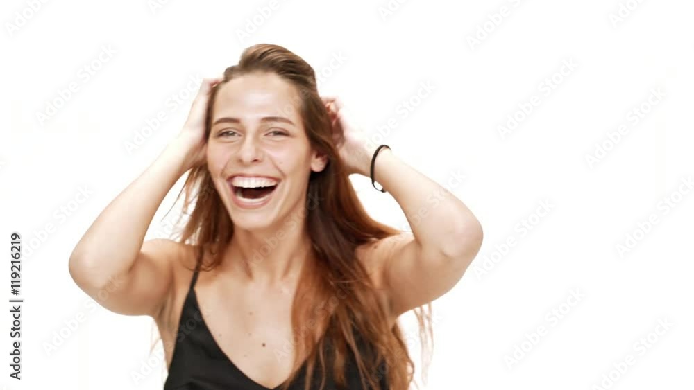 Cheerful young beautiful girl laughing over white background. Cheerful young beautiful girl laughing over white background.