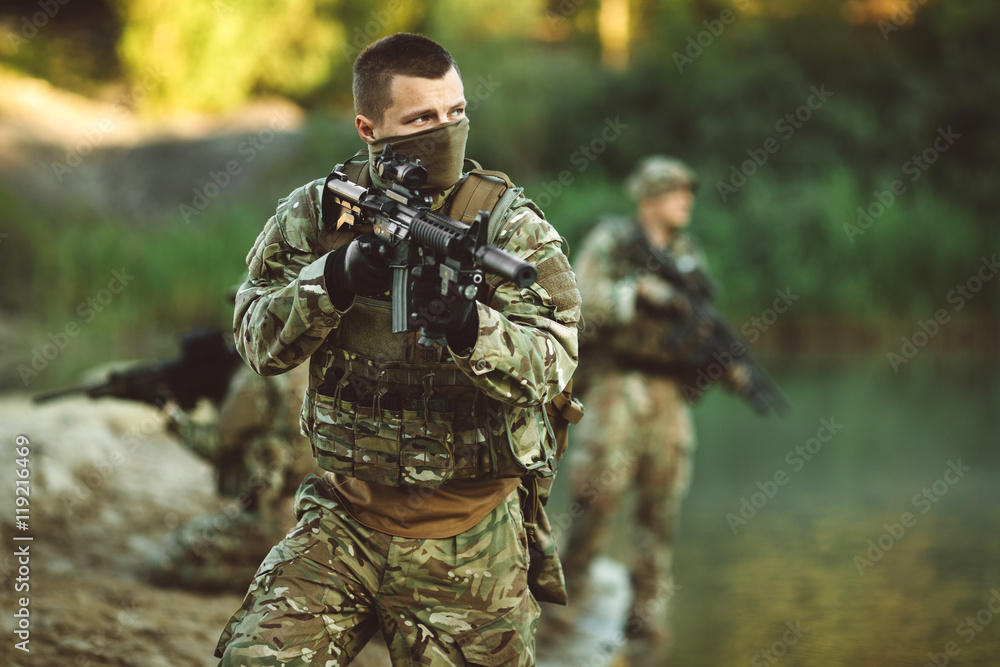 Fototapeta premium Special forces soldiers with weapon take part in military maneuv