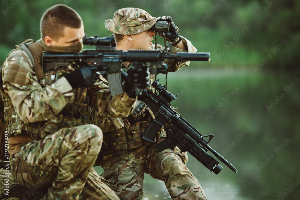 Special forces soldiers with weapon take part in military maneuv Special forces soldiers with weapon take part in military maneuv