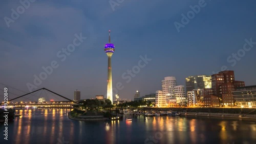 Reflection in the river rhine of the harbor district Dusseldorf in the evening