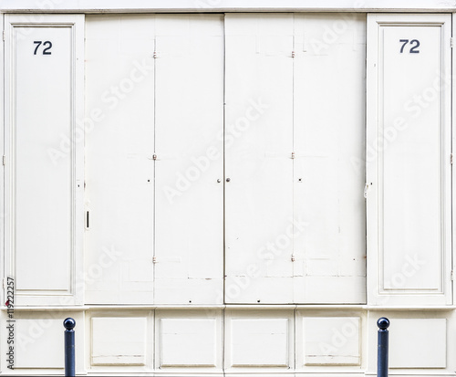 Antique white wooden doors of a store.