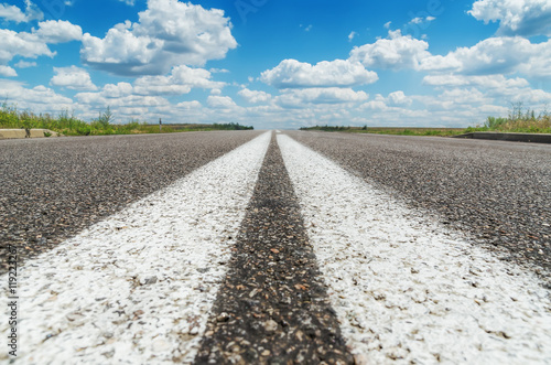 two white line on asphalt road closeup