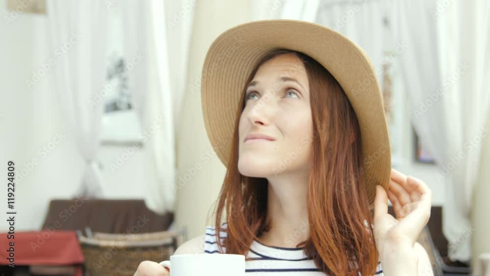 beautiful young girl in outdoor cafe reading a book and drinking tea. beautiful young girl in outdoor cafe reading a book and drinking tea.