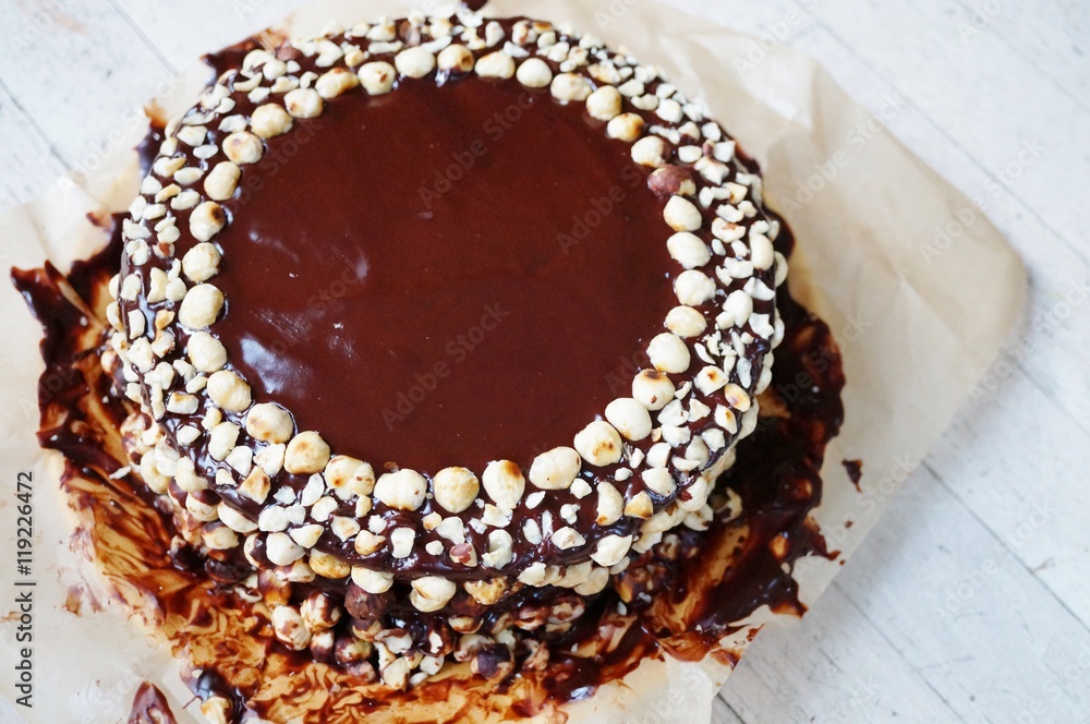 Icing a chocolate and hazelnut cake in the kitchen Icing a chocolate and hazelnut cake in the kitchen