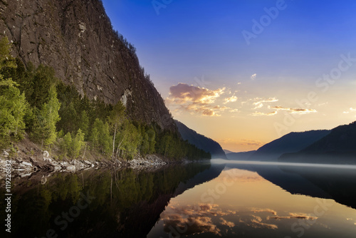 Mountain landscape with the sunrise and the river