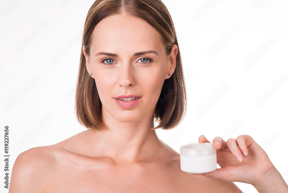Beautiful young woman holding cream Beautiful young woman holding cream