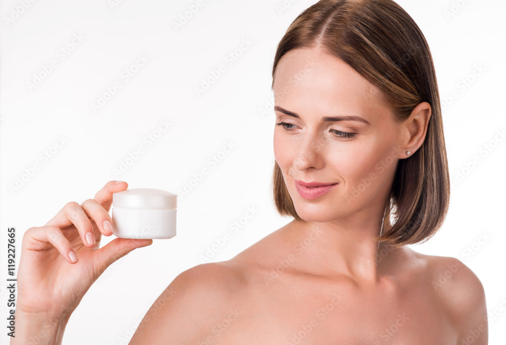 Pretty young woman holding cream Pretty young woman holding cream