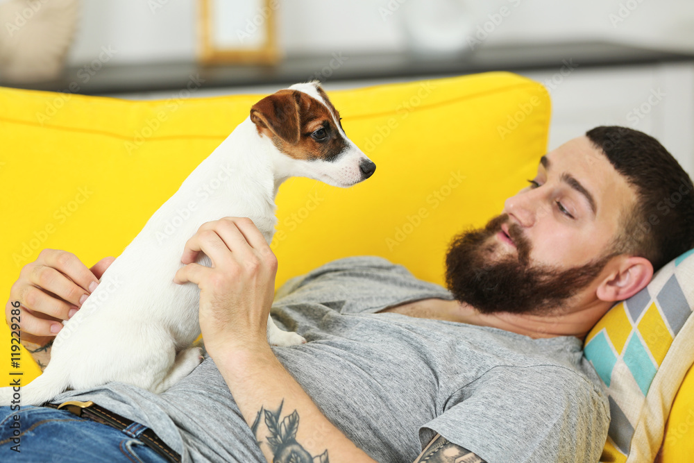 Handsome man with cute dog at home Handsome man with cute dog at home