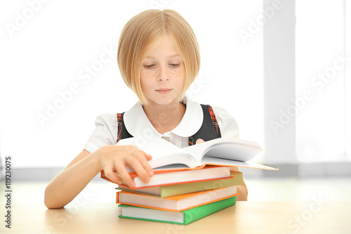 Girl with many books at school