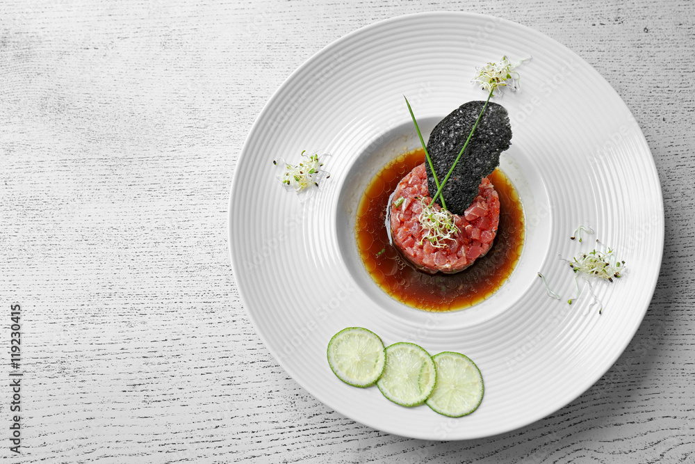 Delicious red fish with sauce and lime slices on white plate Delicious red fish with sauce and lime slices on white plate