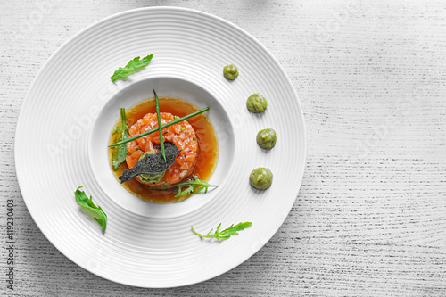 Fototapeta Naklejka Na Ścianę i Meble -  Delicious red fish with sauce on white plate