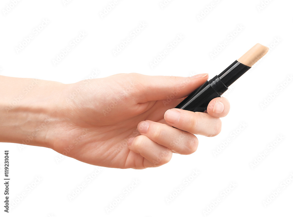 Female hand holding concealer pencil, isolated on white Female hand holding concealer pencil, isolated on white