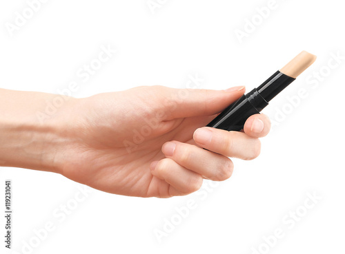 Female hand holding concealer pencil  isolated on white