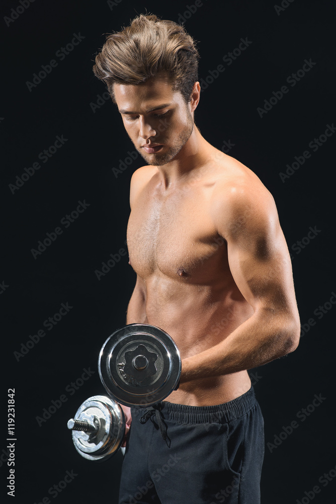 Cheerful serious man lifting weights