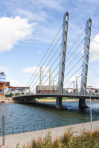 White suspension bridge over a river