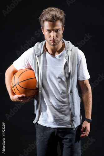 Skillful basketball player posing with confidence