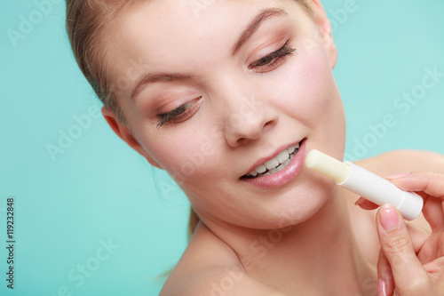 woman applying balsam for lips