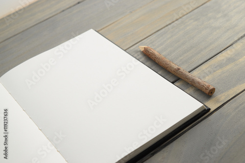 Close-up of Blank notebook with wooden pencil
