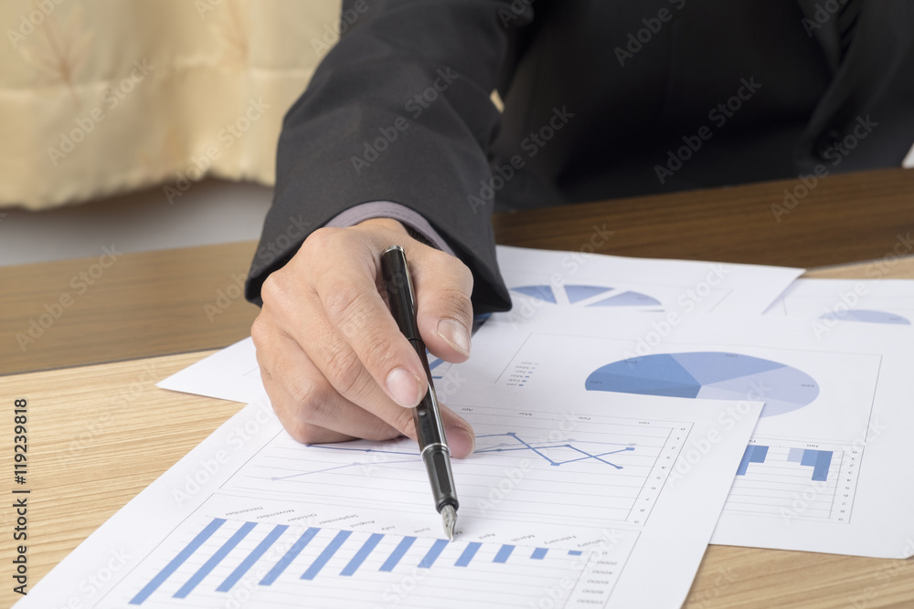 Business man hand pointing at business document during discussion at meeting Business man hand pointing at business document during discussion at meeting