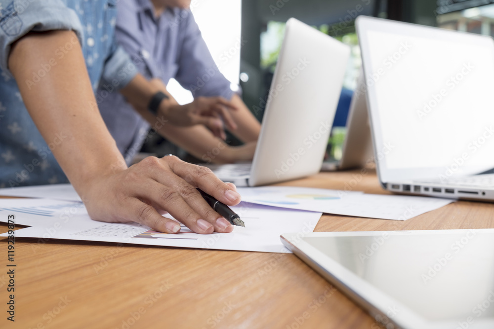 Fototapeta premium Business man hand pointing at business document during discussion at meeting