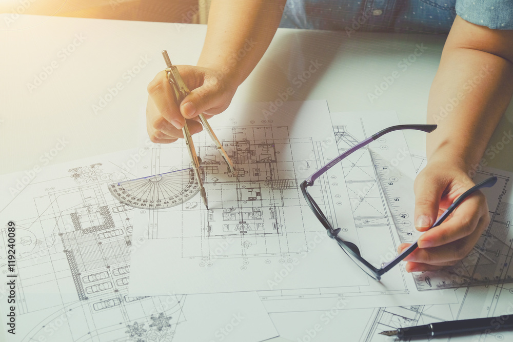 Close up man working of Architect sketching a construction project on his plane project at site construction work Close up man working of Architect sketching a construction project on his plane project at site construction work