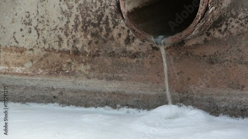 stream of industrial white pulluted water photo