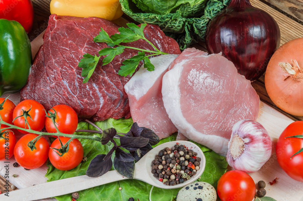 Raw meat and spices on rustic wooden board Raw meat and spices on rustic wooden board
