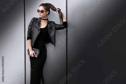 Fashion portrait of young elegant brunette woman outdoor.