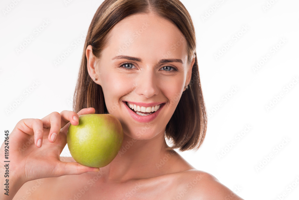 Delighted young woman holding fruits Delighted young woman holding fruits