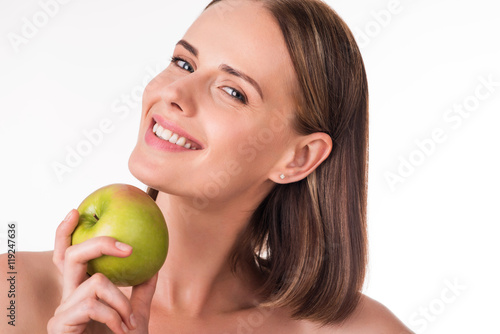 Merry young woman with apple