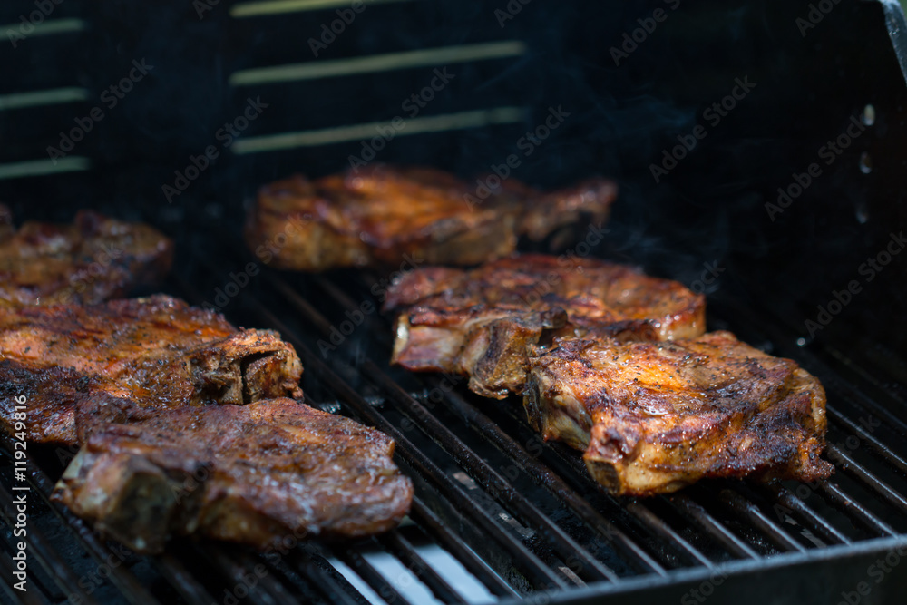 baked pork steak on bbq grill close-up