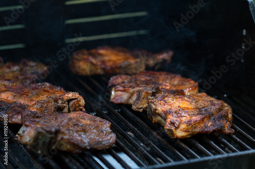 baked pork steak on bbq grill close-up