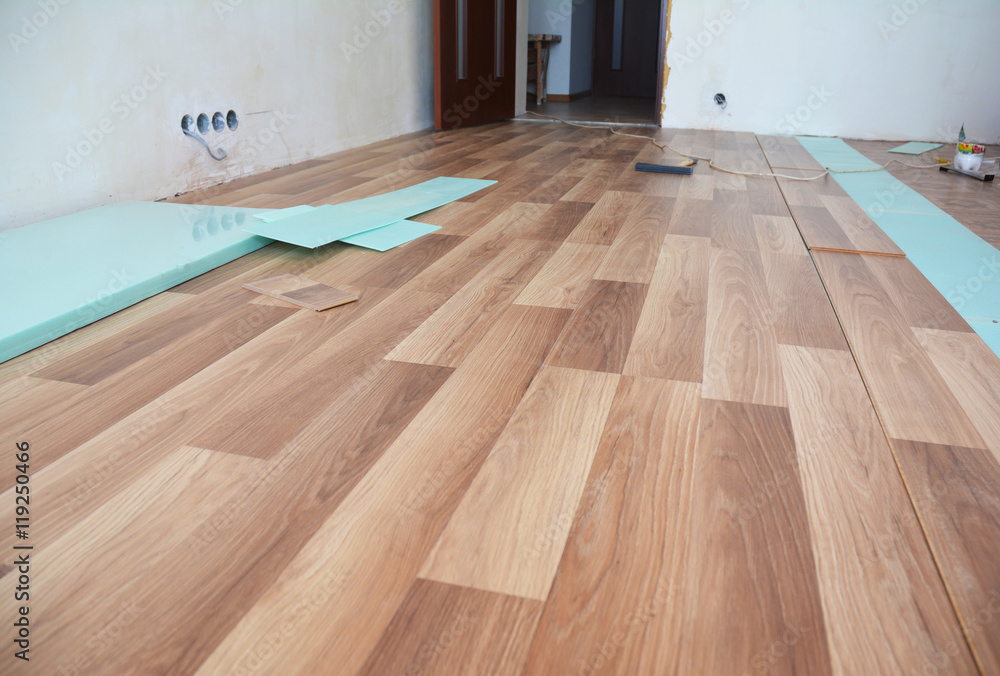 Laminate flooring interior. Installing wooden laminate flooring. - obrazy, fototapety, plakaty 