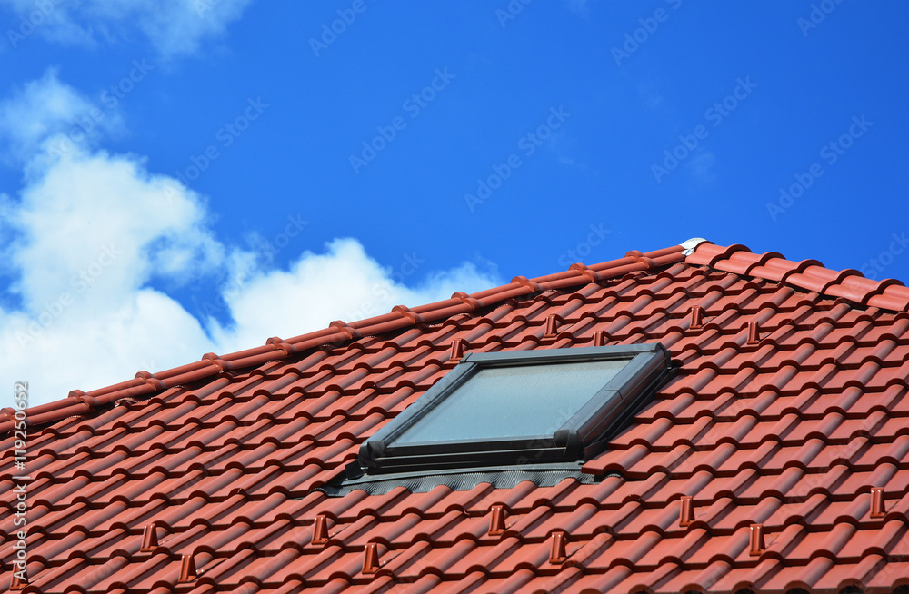 Skylight on red ceramic tiles house roof. Skylights, Roof Windows and Sun Tunnels. Skylight on red ceramic tiles house roof. Skylights, Roof Windows and Sun Tunnels.