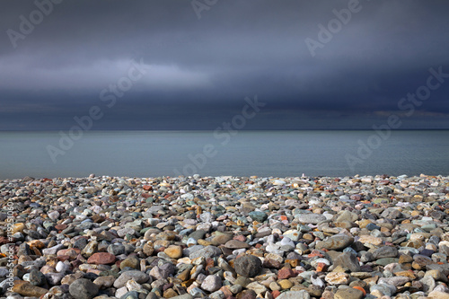 Llandudno beach Pebble covered beach and a stormy sky at Llandudno, North Wales.