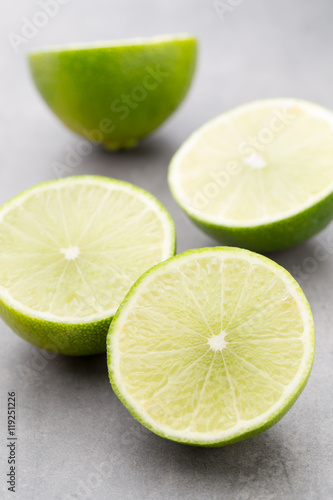 Juicy ripe lime an gray table.