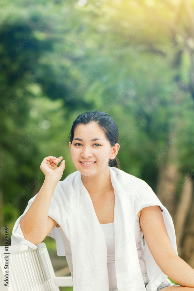 Young asian woman relaxing outdoors looking happy and smiling Young asian woman relaxing outdoors looking happy and smiling