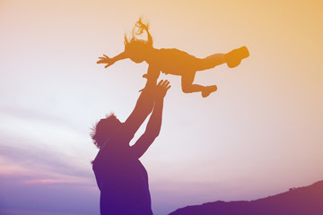 Happy family fathers day concept. Father throwing daughter