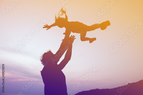 Billede på lærred Happy family fathers day concept. Father throwing daughter