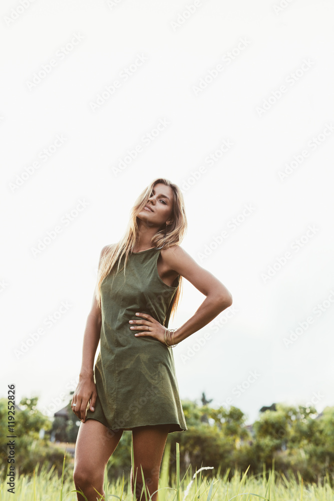 Caucasian female model standing in remote field Caucasian female model standing in remote field