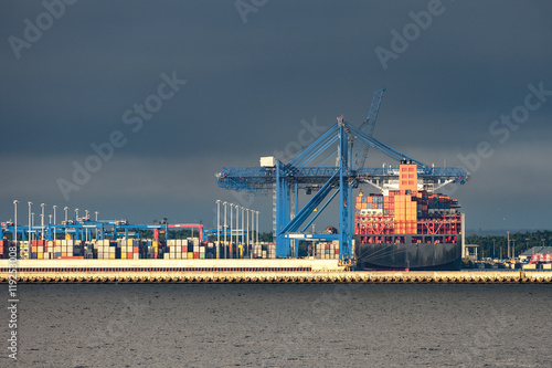 Stormy sea sky with container terminal in port.