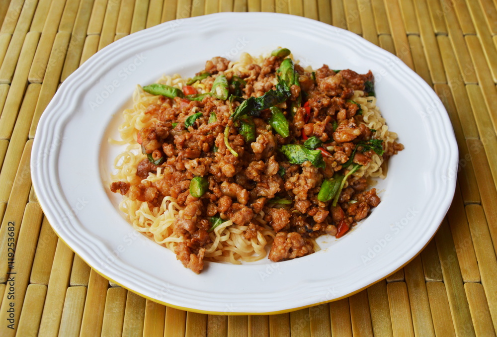 instant noodle topping spicy stir fried chop pork and basil leaf on dish instant noodle topping spicy stir fried chop pork and basil leaf on dish