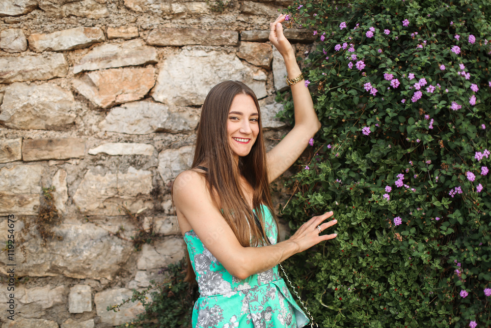cute girl standing at the wall flower cute girl standing at the wall flower