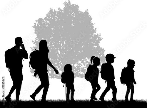 Family reaching with backpacks on a trip.