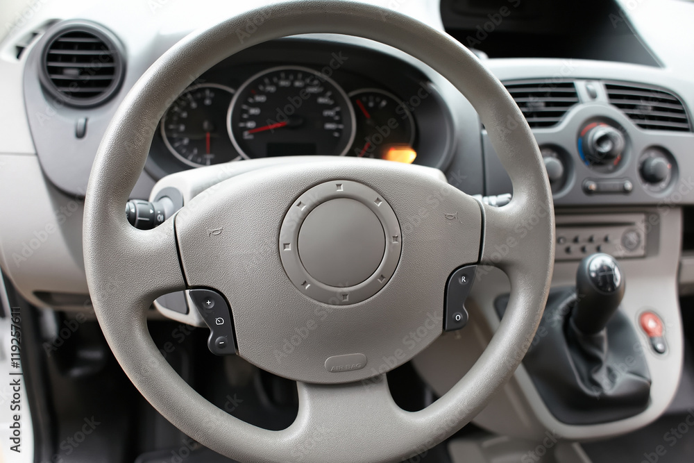 Interior car. Beige steering wheel of the car.