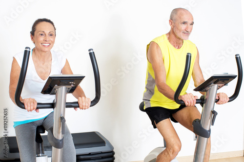 senior couple on indoor bike during spinning exercise